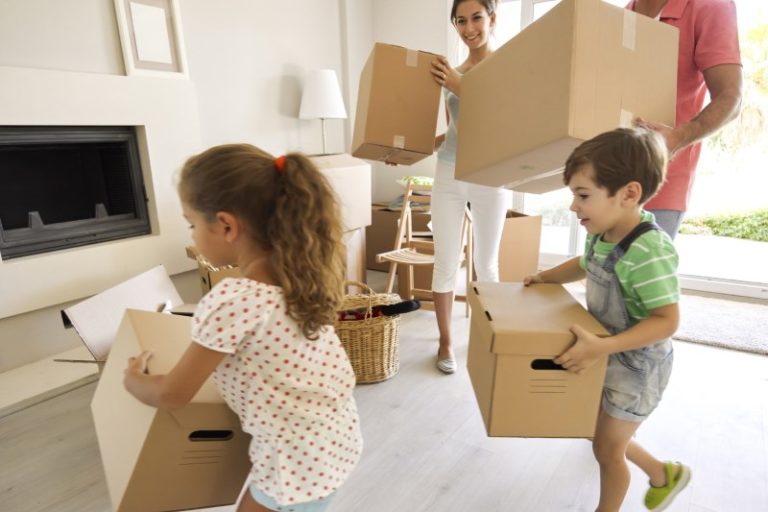 family carrying moving boxes