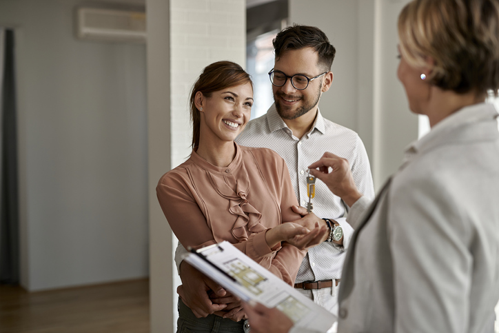 Couple getting keys to a home