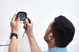 Man installing home security camera