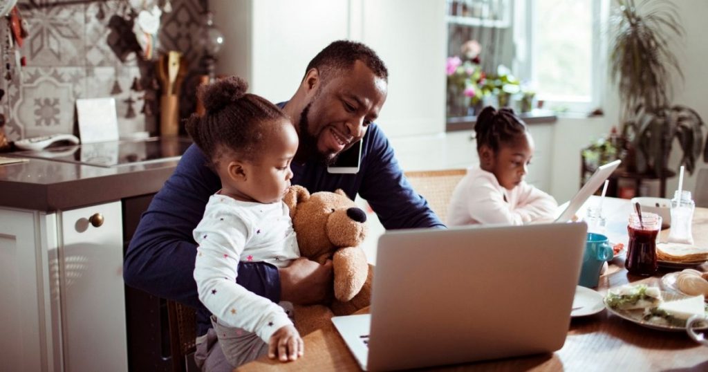 Man with daughters work on several devices