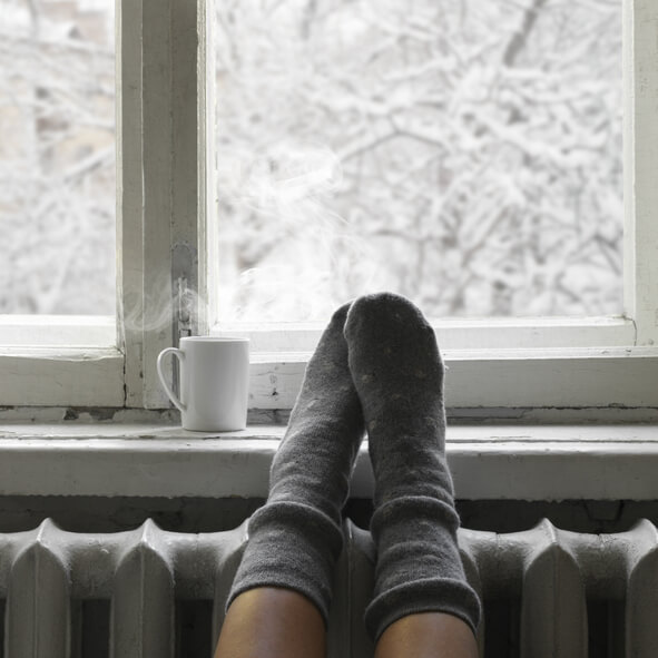 View of snow falling out of an apartment window