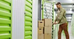 Man pushing boxes into storage unit