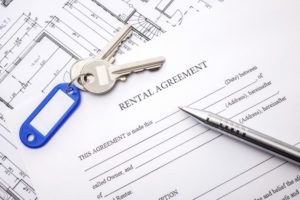 Rental agreement document with keys and pencil