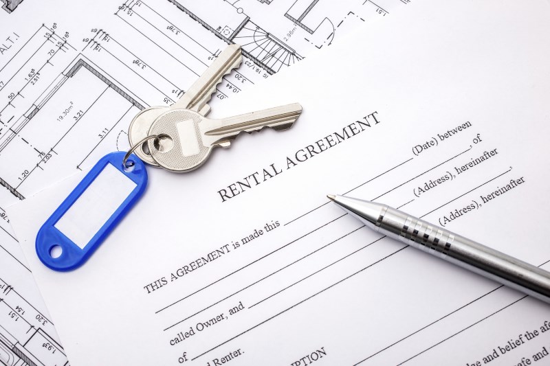 Rental agreement document with keys and pencil