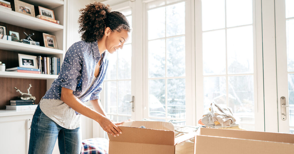 Woman packing moving boxes