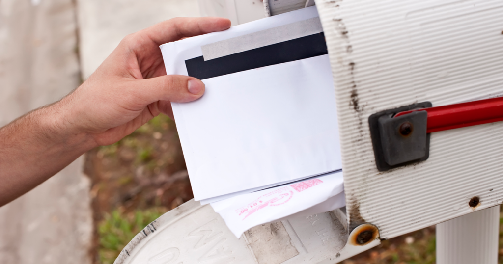 Person reaching into a mailbox