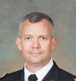 A military helicopter pilot dressed in his uniform.