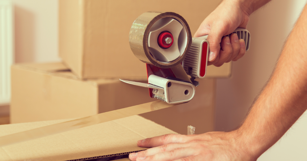 Person taping a moving box