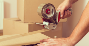 Person taping a moving box